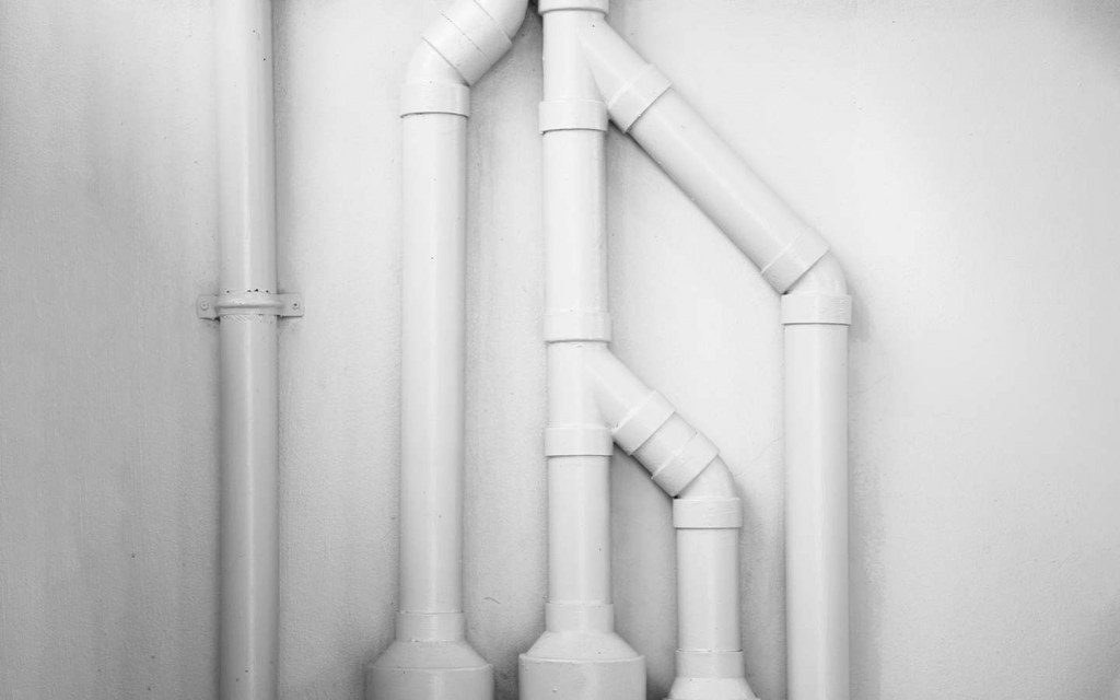 New white PVC pipes installed on a wall