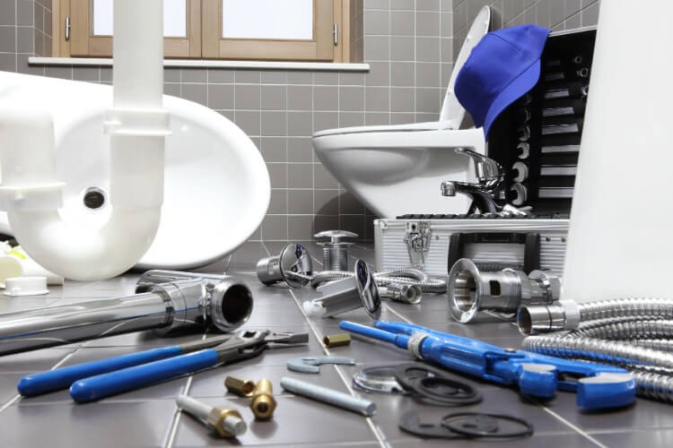 Bathroom plumbing fixtures and tools during a job
