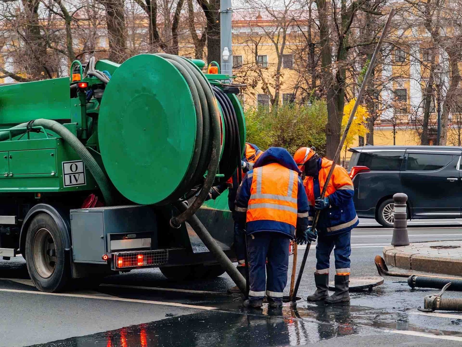 Crew with a hydrojetting truck working at a street drain