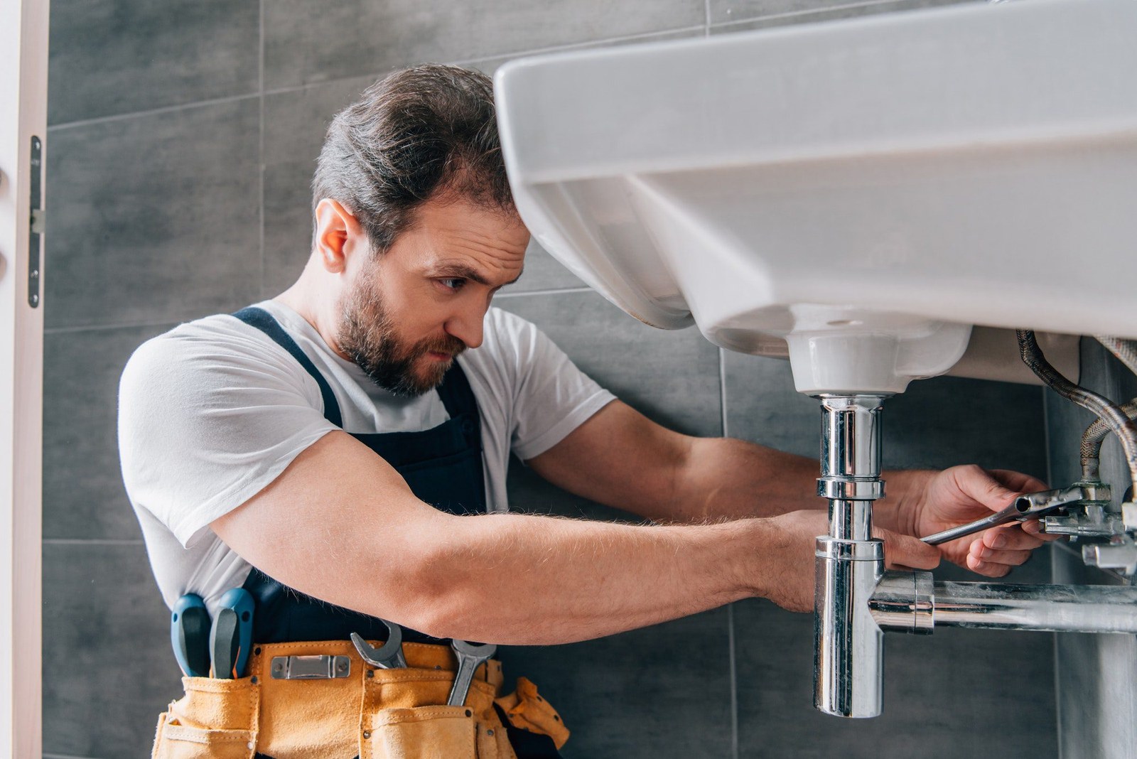 Plumber fixing a bathroom sink